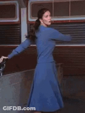 A Blurred Image Of A Woman With A Red Light Behind Her GIF