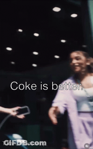 A Blurred Image Of A Woman With The Words Coke Is Better On The Bottom GIF