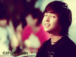 A Blurred Image Of A Young Man With A Necklace Around His Neck And A Black Shirt GIF