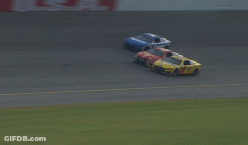 A Blurred Image Of Cars Racing On A Track With A Sign That Says Coca Cola GIF