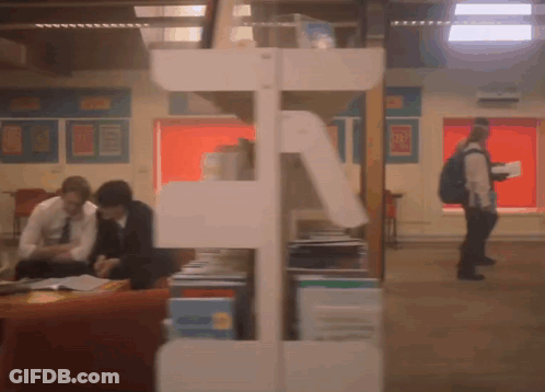 A Blurred Image Of People In A Library With A Sign On The Wall That Says ' A ' GIF