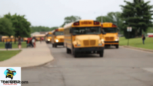 A Blurred Image Of School Buses With The Foundation Logo On The Bottom GIF