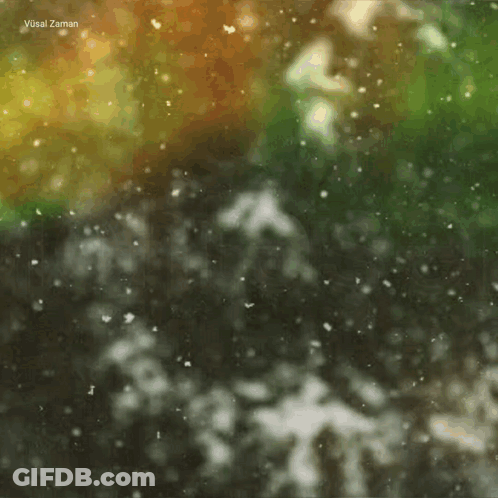 A Blurred Image Of Snow Falling With The Words Vusal Zaman At The Top GIF