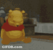 A Blurred Image Of Winnie The Pooh With A Red Shirt On GIF