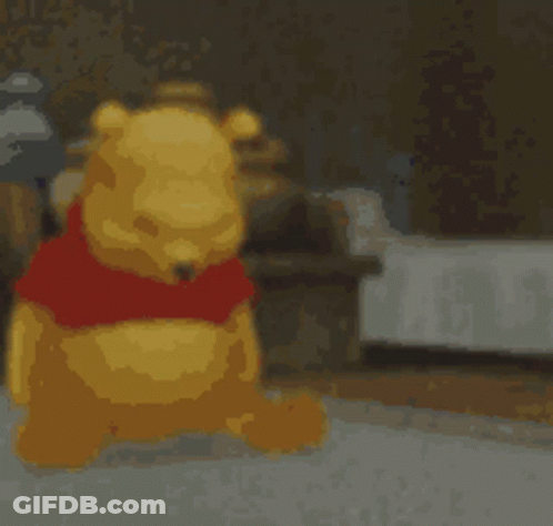 A Blurred Image Of Winnie The Pooh With A Red Shirt On GIF