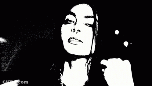 A Blurry Black And White Photo Of A Person 'S Face With Smoke Coming Out Of It . GIF