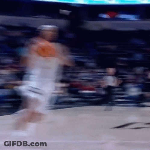 A Blurry Image Of A Basketball Player Dribbling A Ball GIF