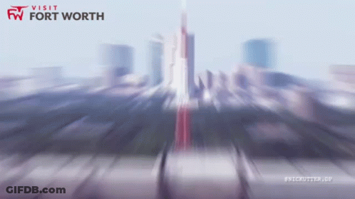 A Blurry Image Of A City With The Words Visit Fort Worth GIF