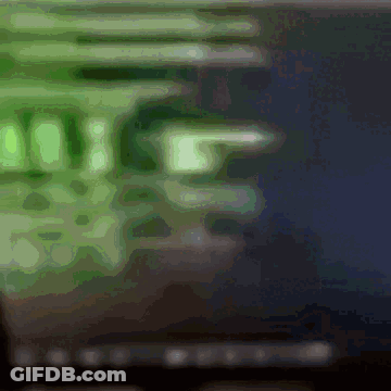 A Blurry Image Of A Computer Screen With A Green Glow GIF