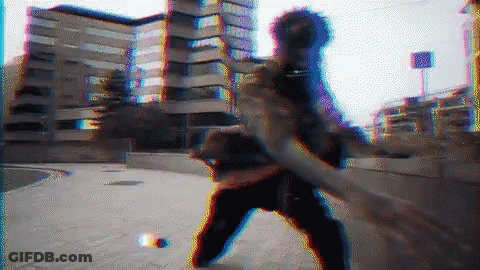 A Blurry Image Of A Person Standing On A Sidewalk With A Building In The Background GIF