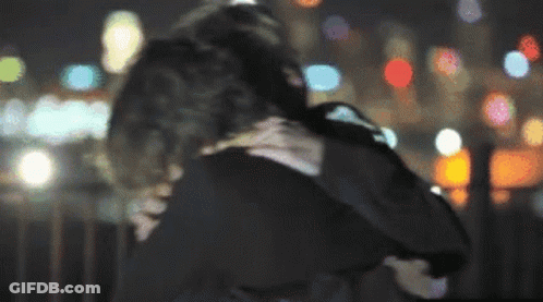 A Blurry Photo Of A Man And Woman Hugging GIF