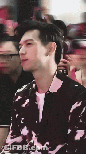A Blurry Photo Of A Man In A Black And White Shirt With The Letters Yz On The Bottom Right GIF