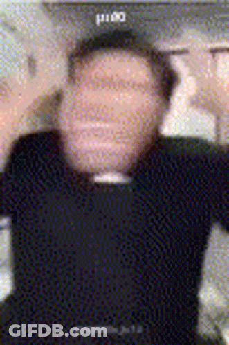 A Blurry Photo Of A Man Wearing A Black Shirt And A Black Hat GIF