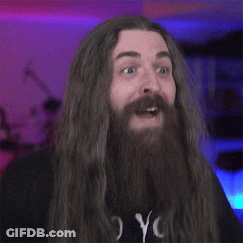 A Blurry Photo Of A Man With Long Hair And A Beard GIF
