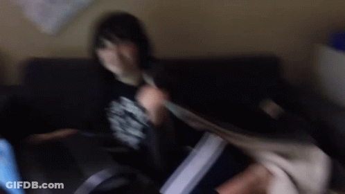A Blurry Photo Of A Person Sitting On A Couch . GIF