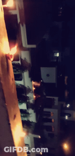 A Blurry Photo Of A Street At Night With A Few Lights On GIF