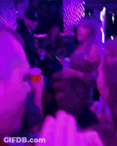 A Blurry Photo Of A Woman Dancing In A Club GIF