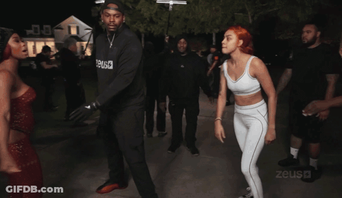 A Blurry Photo Of People Dancing With The Word Zeus Visible In The Corner GIF