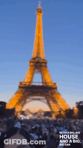 A Blurry Photo Of The Eiffel Tower With The Words With A Big Big House And A Big Big Car Below It GIF