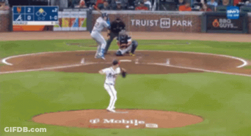 A Blurry Picture Of A Baseball Field With A Scoreboard Behind It GIF