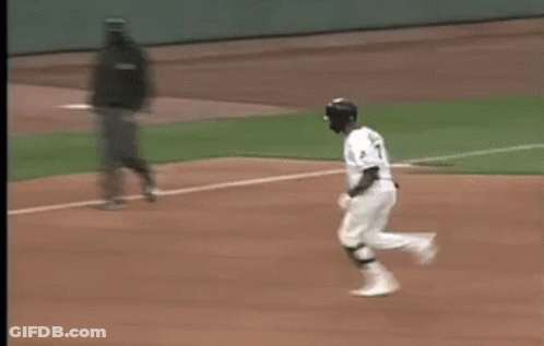 A Blurry Picture Of A Baseball Game With A Coca Cola Ad In The Background GIF
