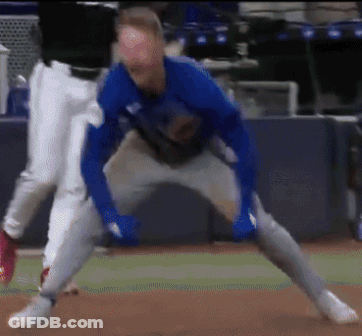 A Blurry Picture Of A Baseball Player In A Blue Shirt GIF