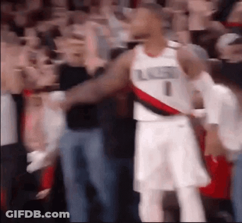 A Blurry Picture Of A Basketball Player Standing In Front Of A Crowd Of People . GIF