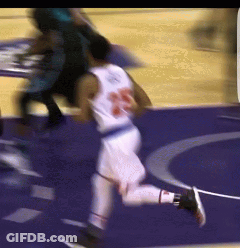 A Blurry Picture Of A Basketball Player Wearing Number 23 GIF