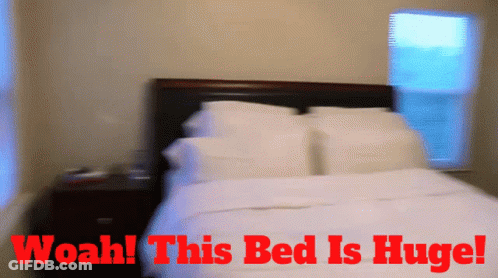 A Blurry Picture Of A Bed With The Words Woah This Bed Is Huge Above It GIF