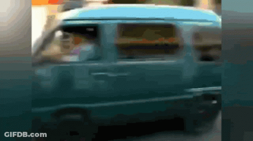 A Blurry Picture Of A Blue Van With A Man Driving GIF