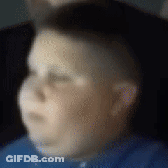 A Blurry Picture Of A Boy In A Blue Shirt With His Eyes Closed GIF