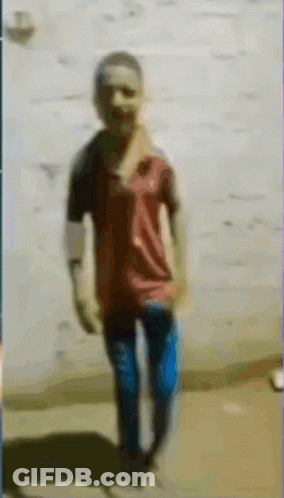 A Blurry Picture Of A Boy In A Red Shirt GIF