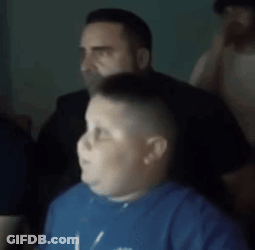 A Blurry Picture Of A Boy Wearing A Blue Shirt That Says ' I Love You ' On It GIF