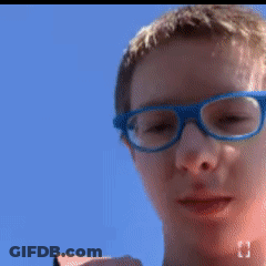 A Blurry Picture Of A Boy Wearing Glasses GIF