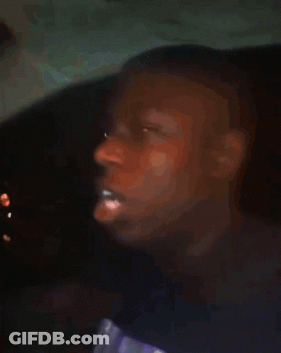 A Blurry Picture Of A Boy With His Eyes Closed GIF