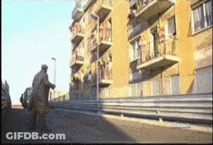 A Blurry Picture Of A Building With Balconies On The Side GIF
