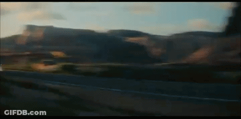 A Blurry Picture Of A Car Driving Down A Road GIF