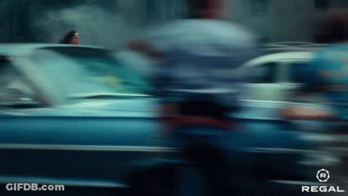 A Blurry Picture Of A Car Driving Down A Street GIF