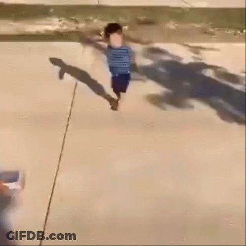 A Blurry Picture Of A Child Walking Down A Street GIF