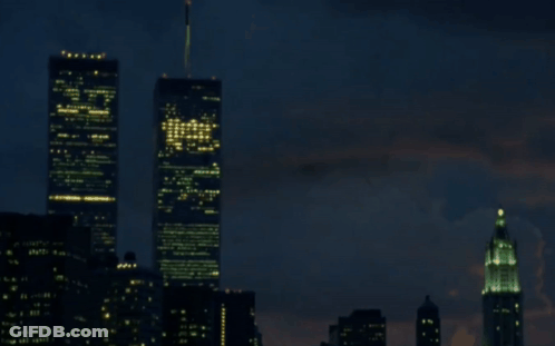 A Blurry Picture Of A City At Night With A Few Buildings Lit Up GIF
