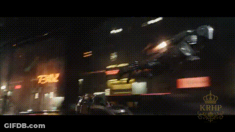 A Blurry Picture Of A City At Night With A Sign That Says 78 On It GIF