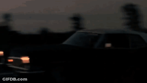 A Blurry Picture Of A City Skyline At Sunset With The Twin Towers Visible GIF