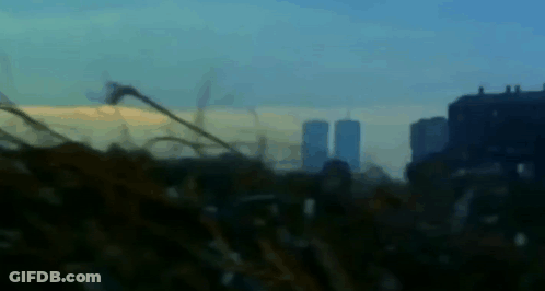 A Blurry Picture Of A City Skyline With A Few Buildings In The Background GIF