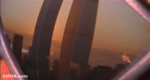 A Blurry Picture Of A City Skyline With A Few Buildings In The Foreground GIF
