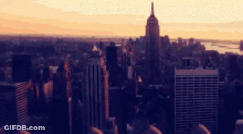 A Blurry Picture Of A City With The Empire State Building In The Distance GIF