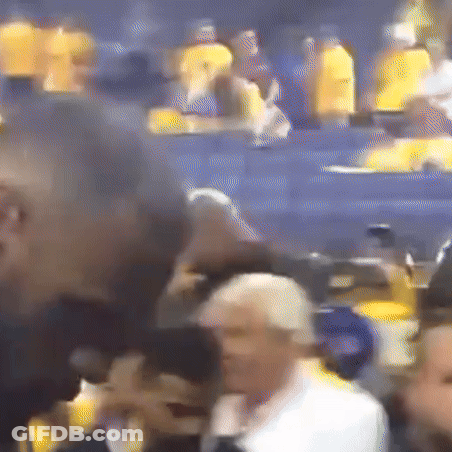 A Blurry Picture Of A Crowd Of People In A Stadium With Yellow Shirts On GIF