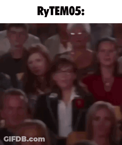 A Blurry Picture Of A Crowd Of People Sitting In A Theater With The Words Rytem05 Written Above Them . GIF