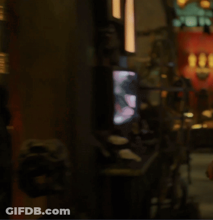 A Blurry Picture Of A Dark Room With A Few Lights Visible GIF