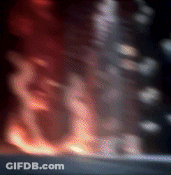 A Blurry Picture Of A Fire Coming Out Of A Building . GIF