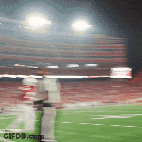 A Blurry Picture Of A Football Field With A Few Players GIF